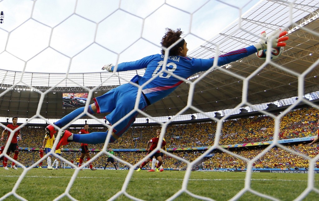 Image: Mexico's goalkeeper Ochoa makes a save on a shot by Brazil's Neymar during their 2014 World Cup Group A soccer match at the Castelao arena in Fortaleza