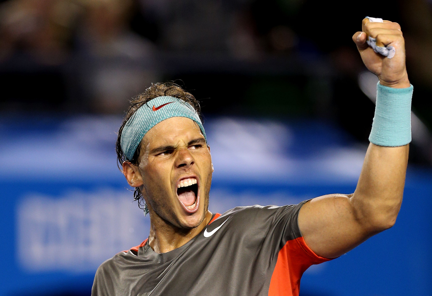MELBOURNE, AUSTRALIA - JANUARY 24: Rafael Nadal of Spain celebrates winning his semifinal match against Roger Federer of Switzerland during day 12 of the 2014 Australian Open at Melbourne Park on January 24, 2014 in Melbourne, Australia. (Photo by Clive Brunskill/Getty Images)