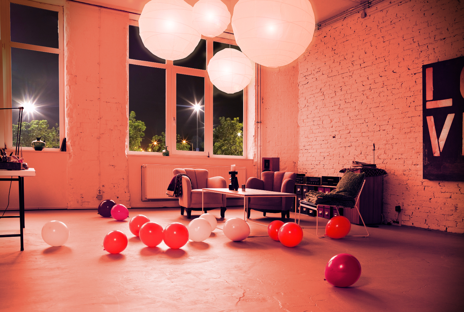Multi colored balloons on the floor of a modern living room